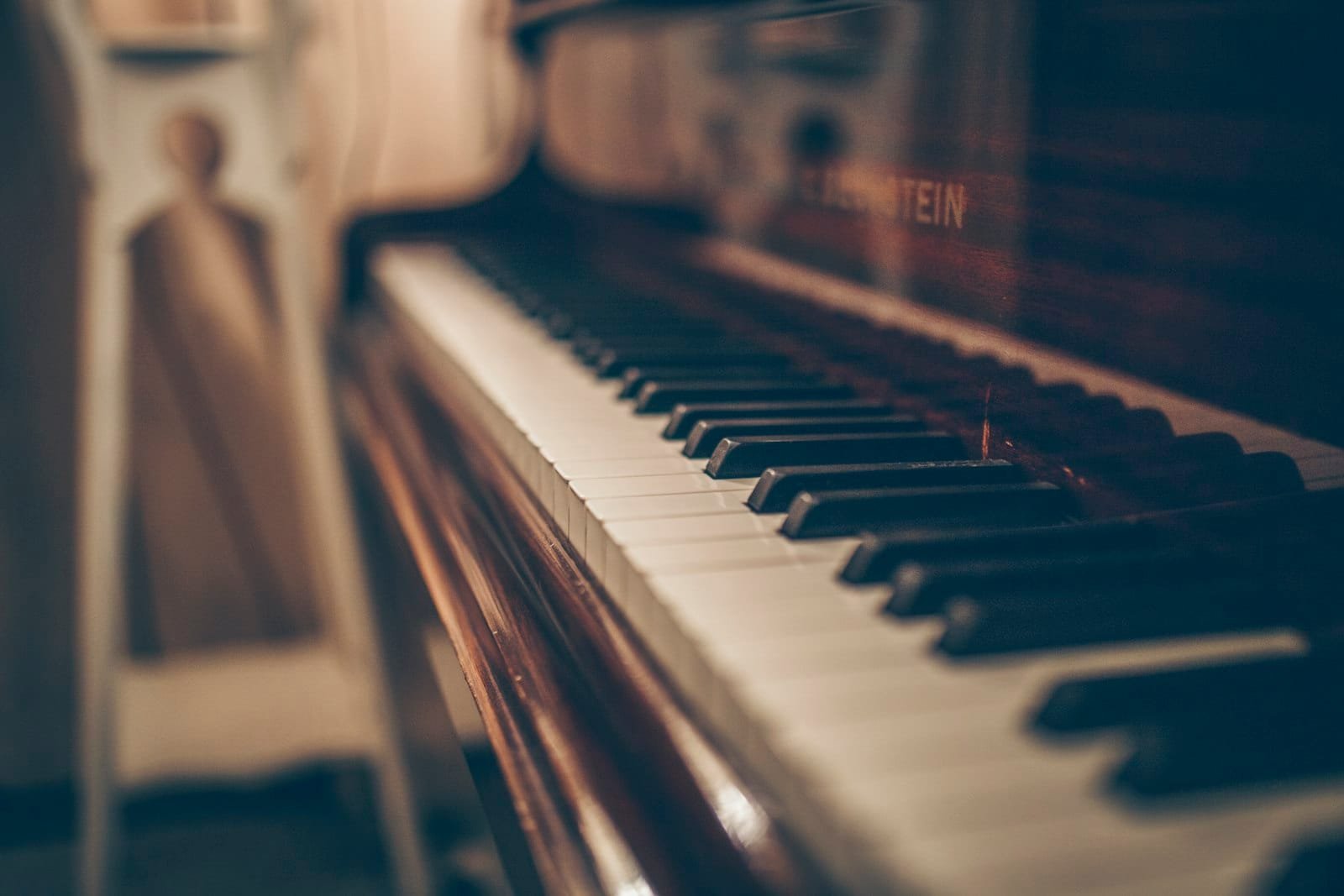 Songwriter writing a melody at a piano in a Dubai recording studio