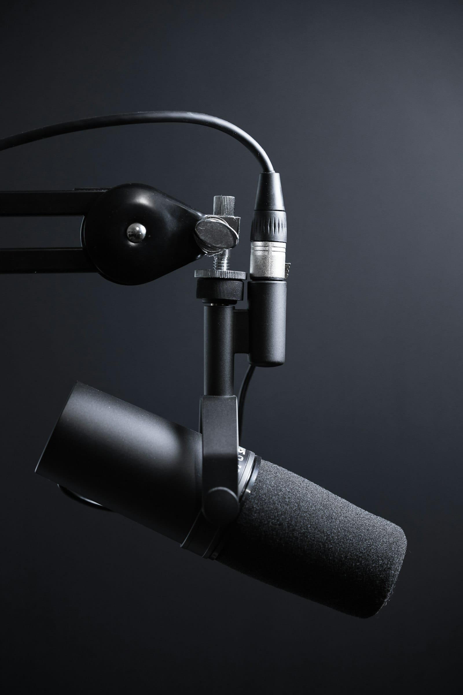 Podcast recording studio in Dubai with a professional condenser microphone and headphones