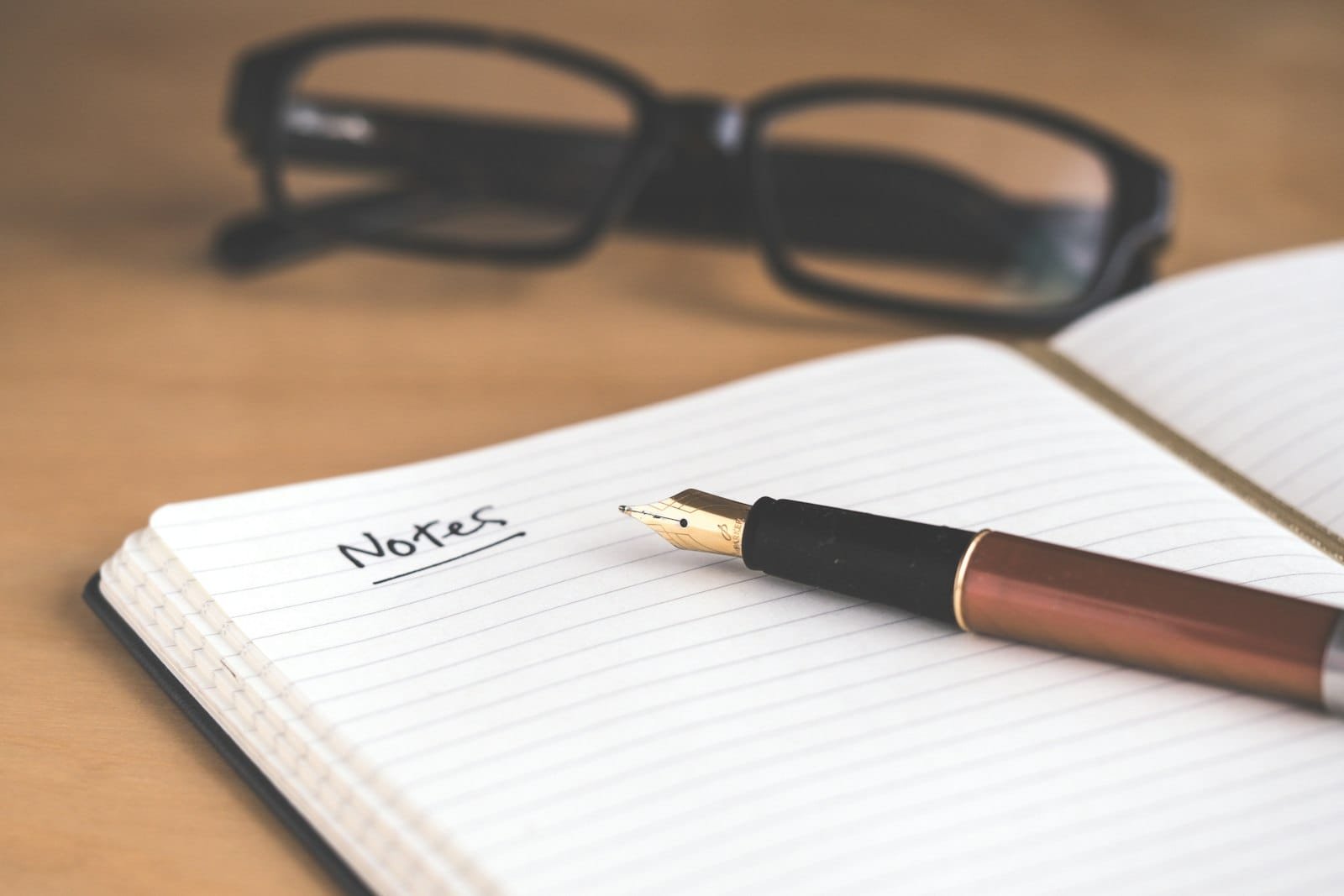 How to write song lyrics — songwriter writing lyrics in a notebook at a Dubai recording studio