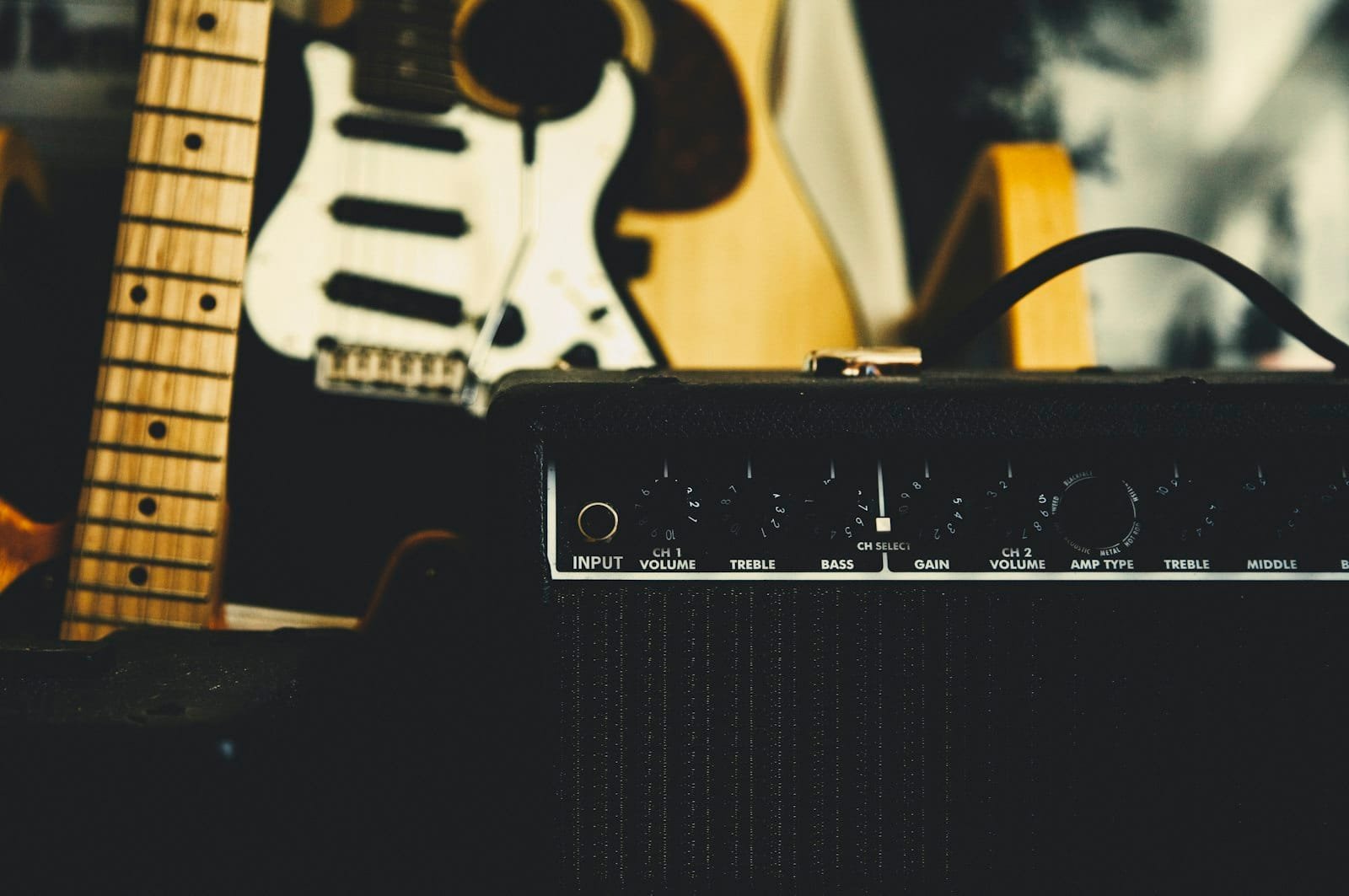 Bass amp beside an electric bass set up to record — choosing between amp and DI