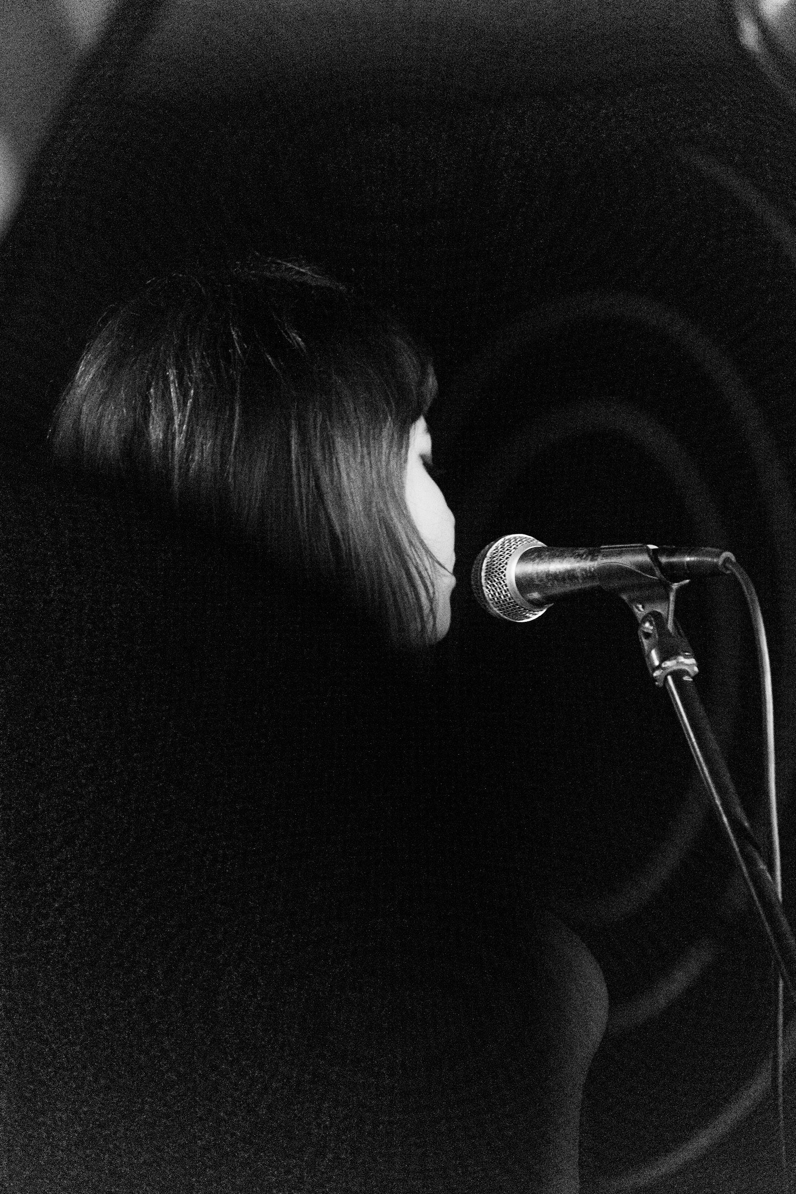 How to sing from your diaphragm - singer using breath support at a microphone in a Dubai recording studio