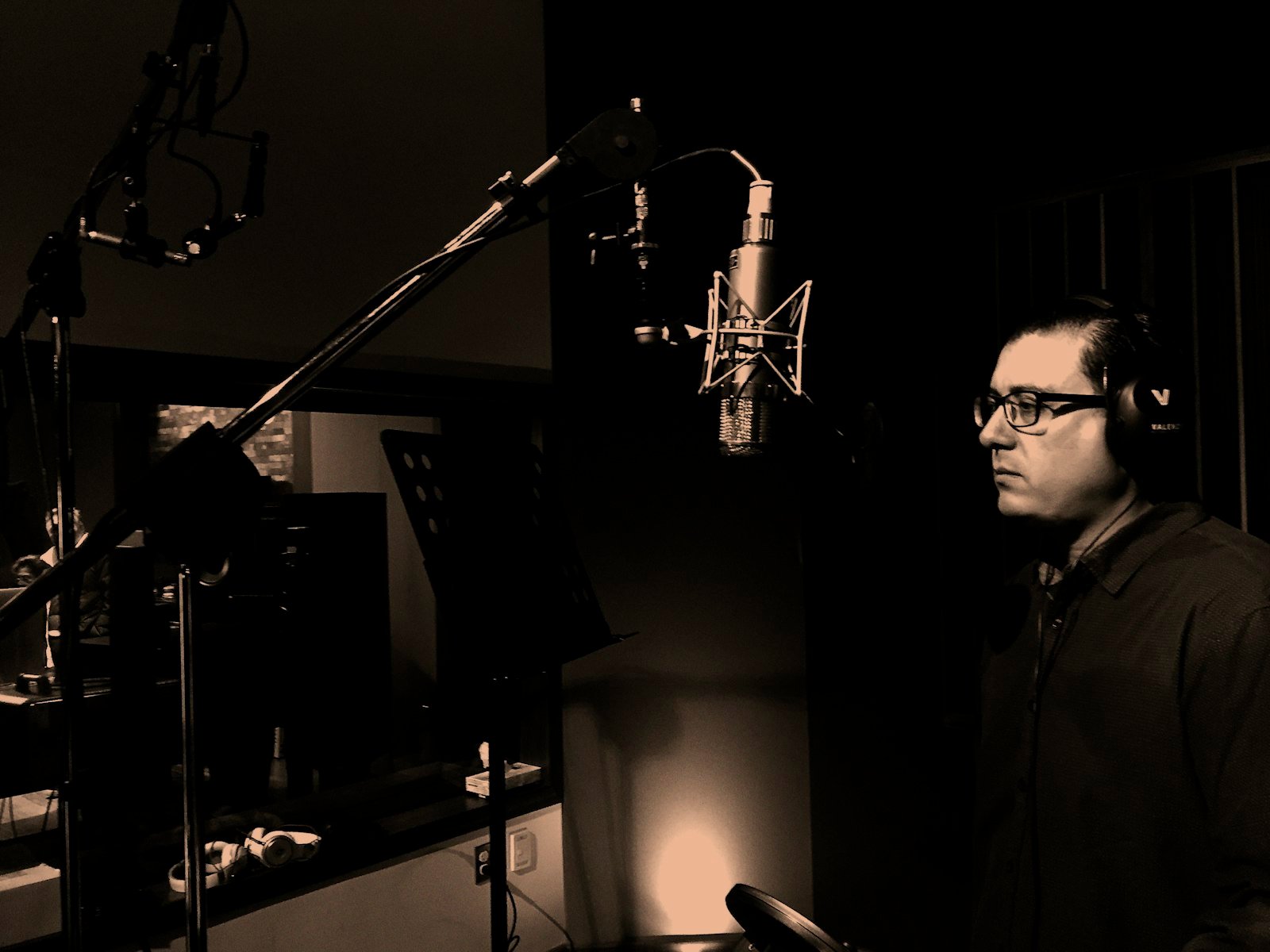 Singer practising diaphragmatic breathing and breath control at a microphone in a Dubai studio