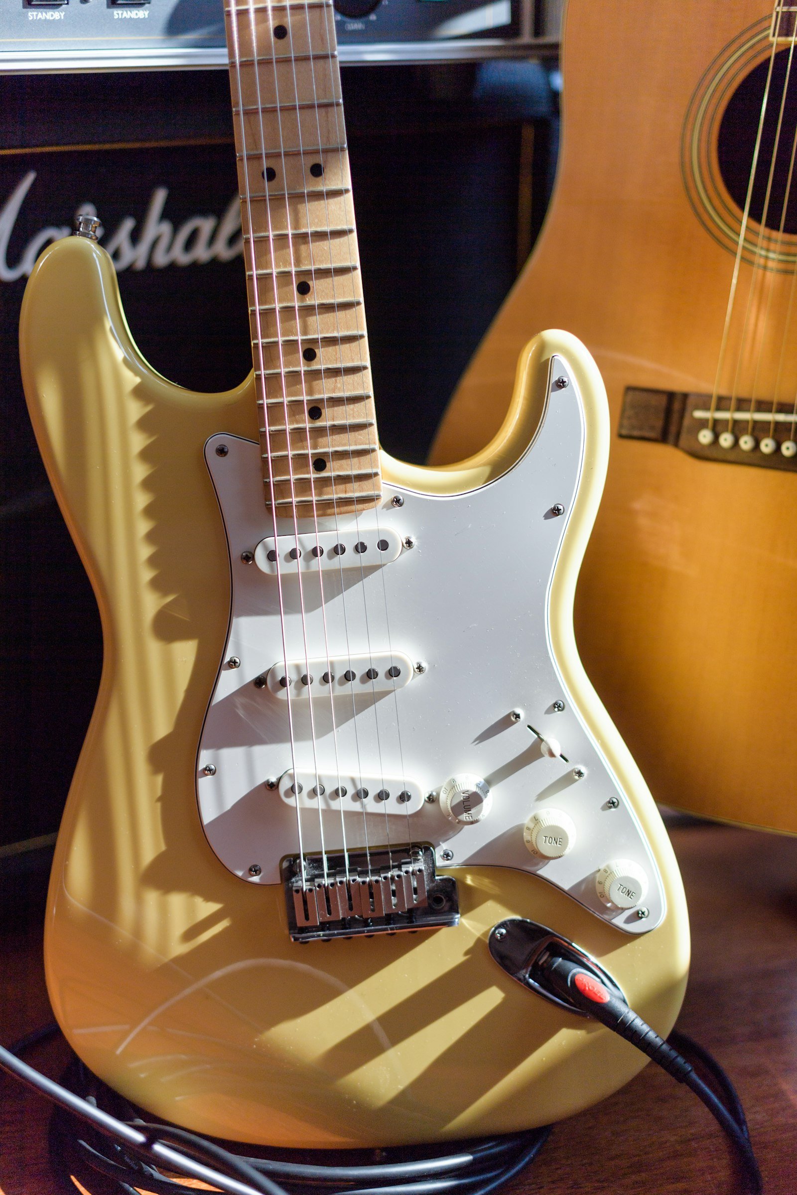 A Stratocaster-style electric guitar ready to record in a Dubai music studio
