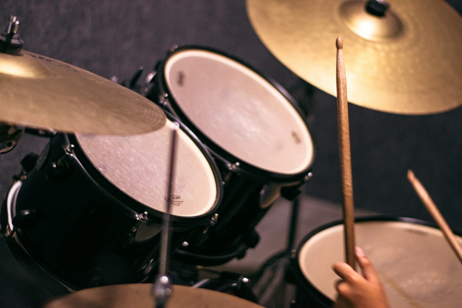 How to record drums — drummer playing a full kit in a Dubai recording studio