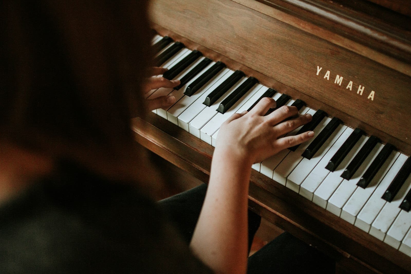 How to record piano - pianist playing a piano ready for recording in a Dubai music studio